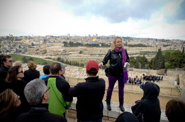 Tisha Michelle talking to a group of tourists in Mount of Olives