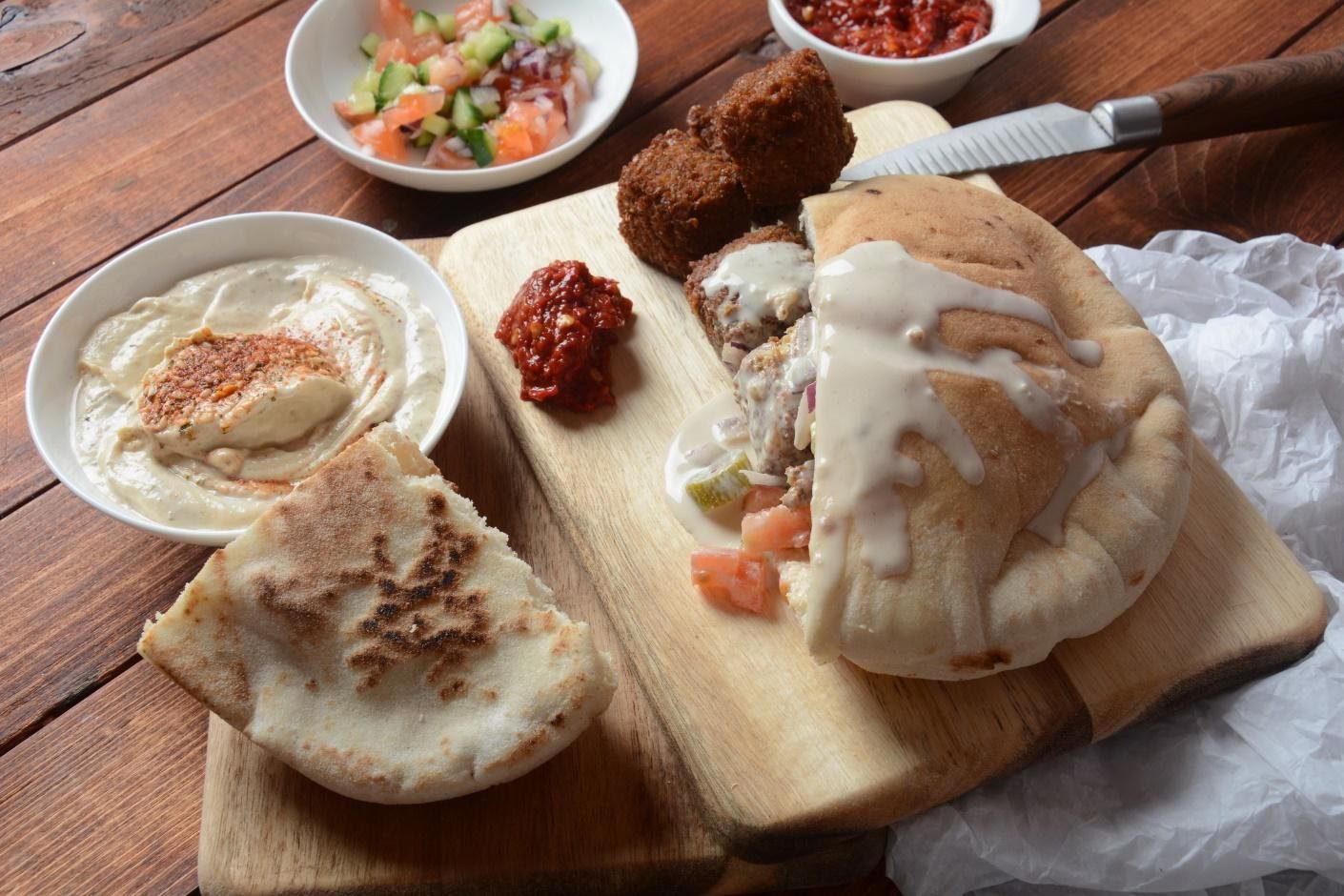 A wooden table topped with lots of food.