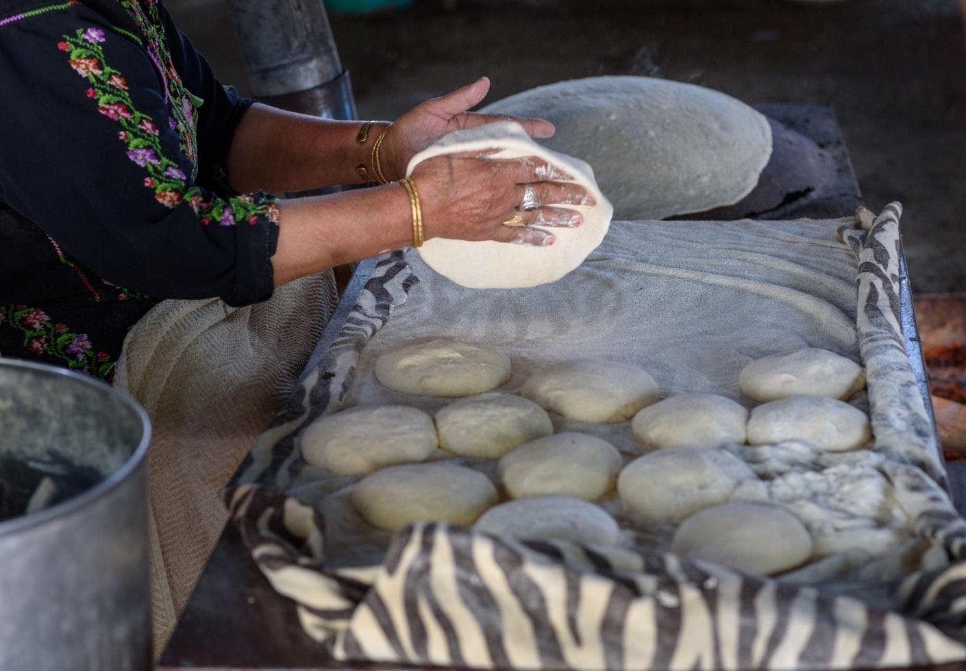 A person is making food on the grill.