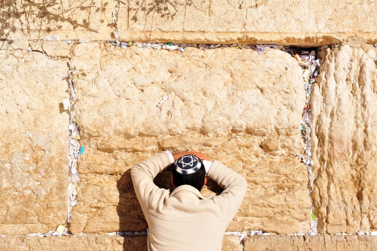 A person is taking pictures of the wall.