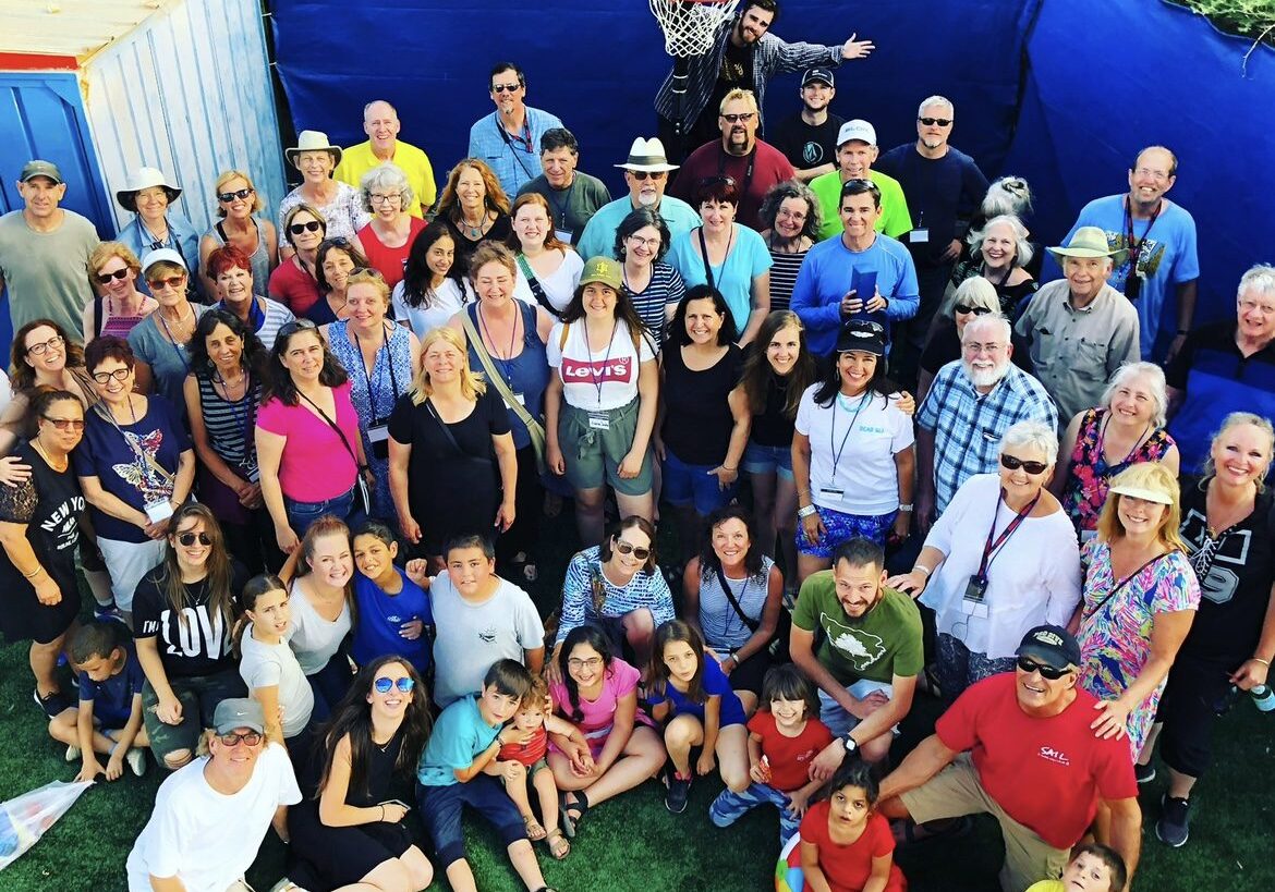 A group of people standing in front of a basketball hoop.